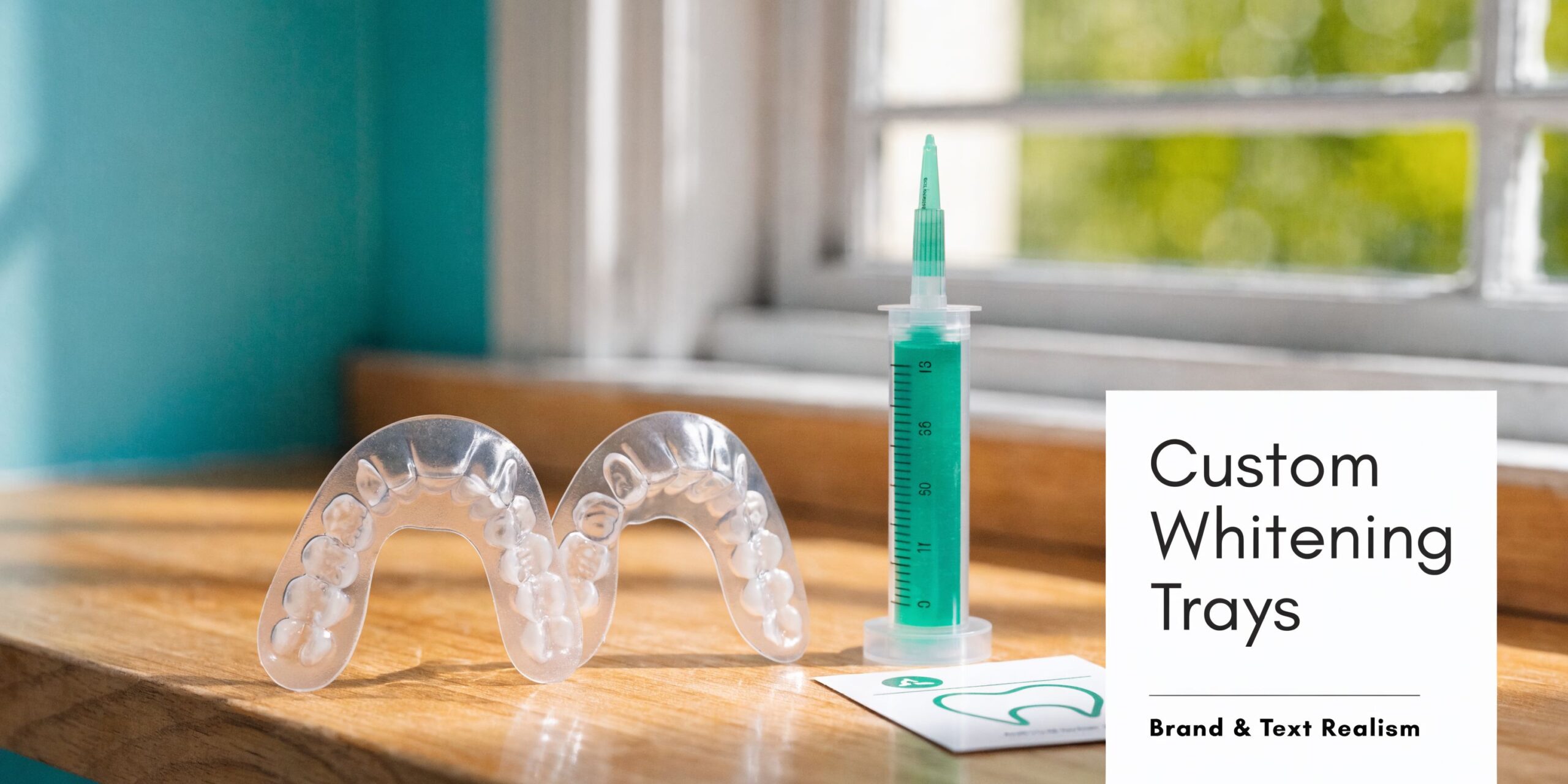 Clear dental whitening trays and a syringe of bleaching gel placed on a wooden window sill.
