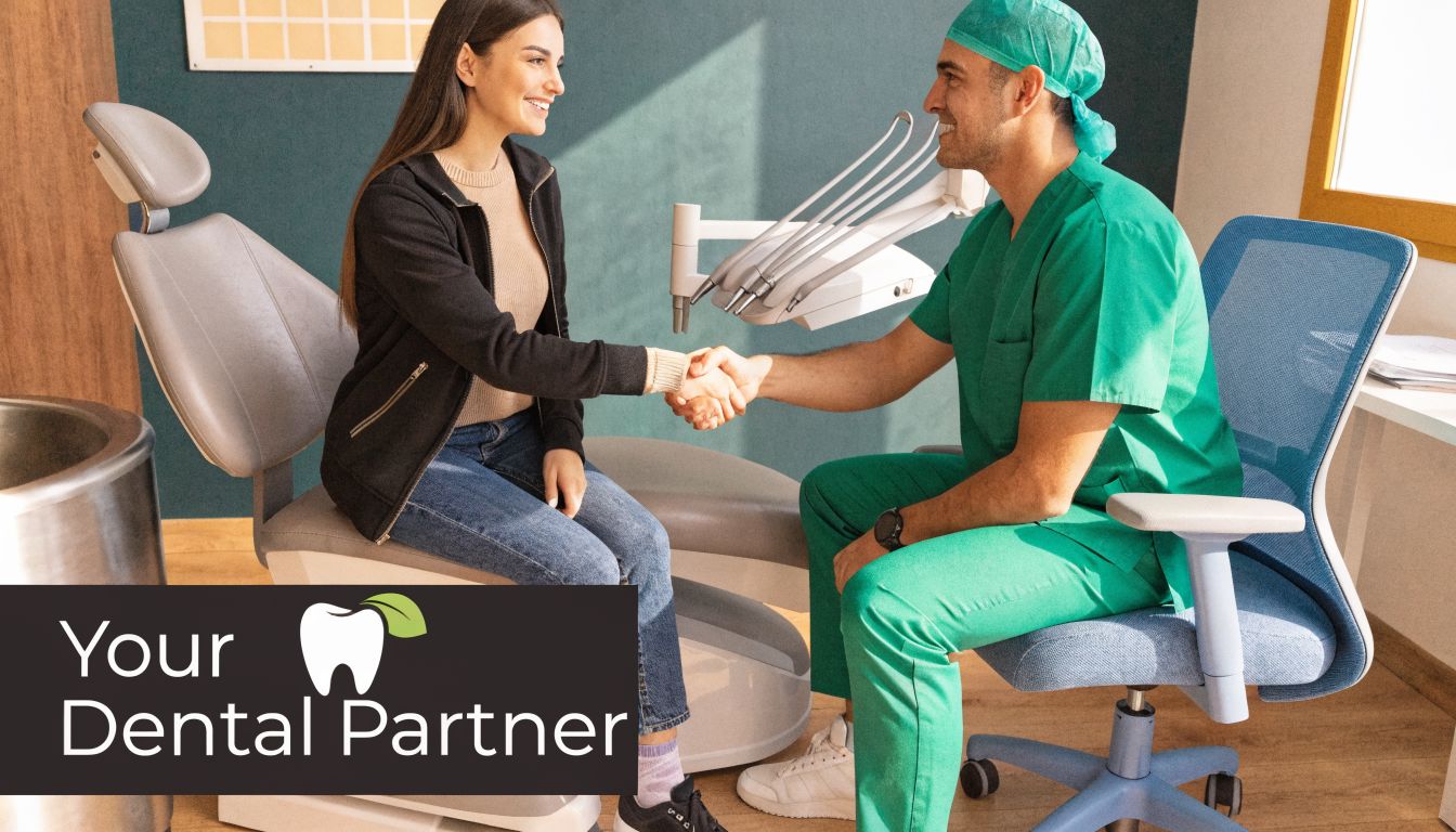 A friendly dentist shaking hands with a smiling female patient sitting in the dental chair.