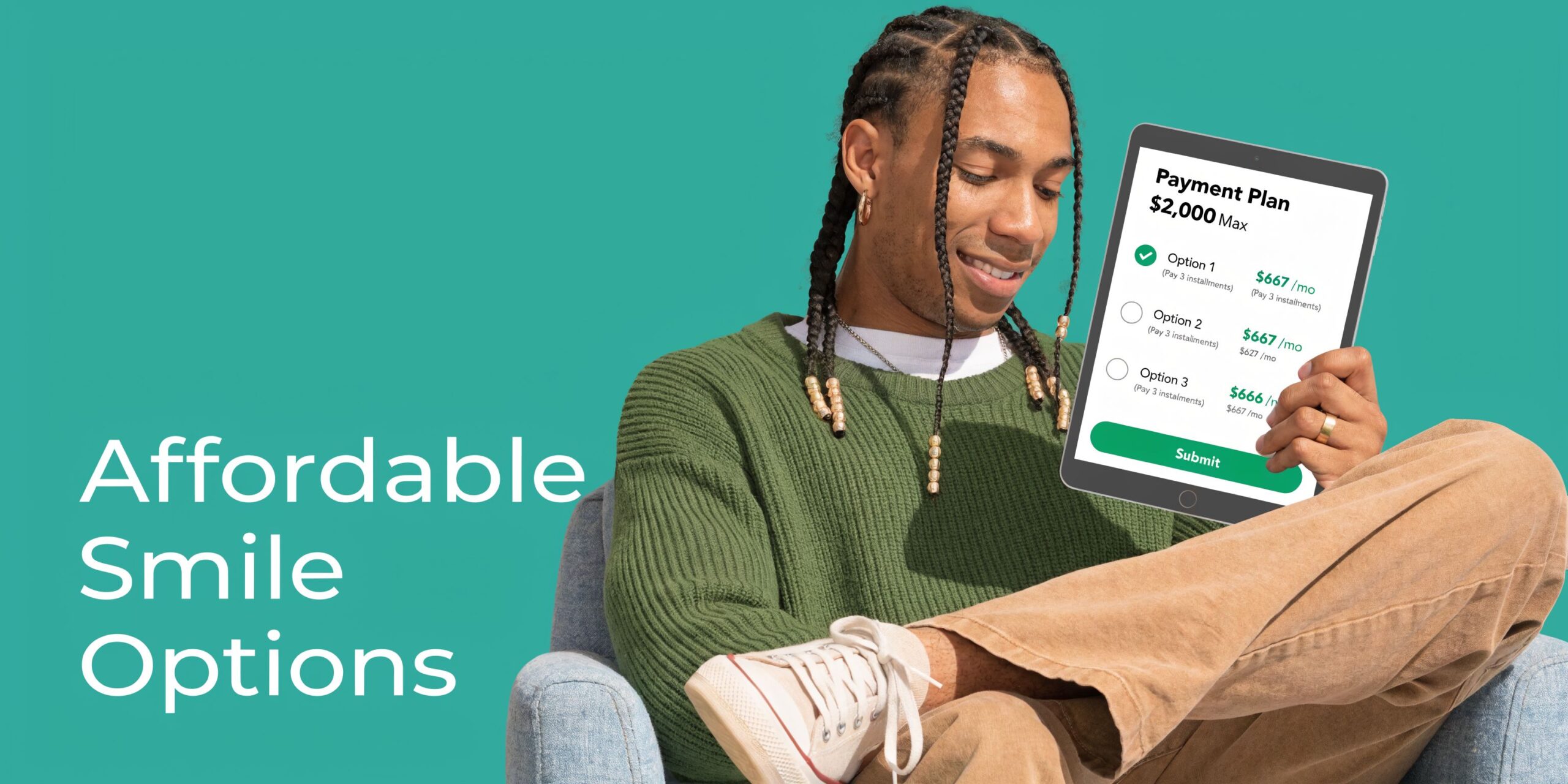 A young man sitting in an armchair while looking at dental payment plan options on a tablet.