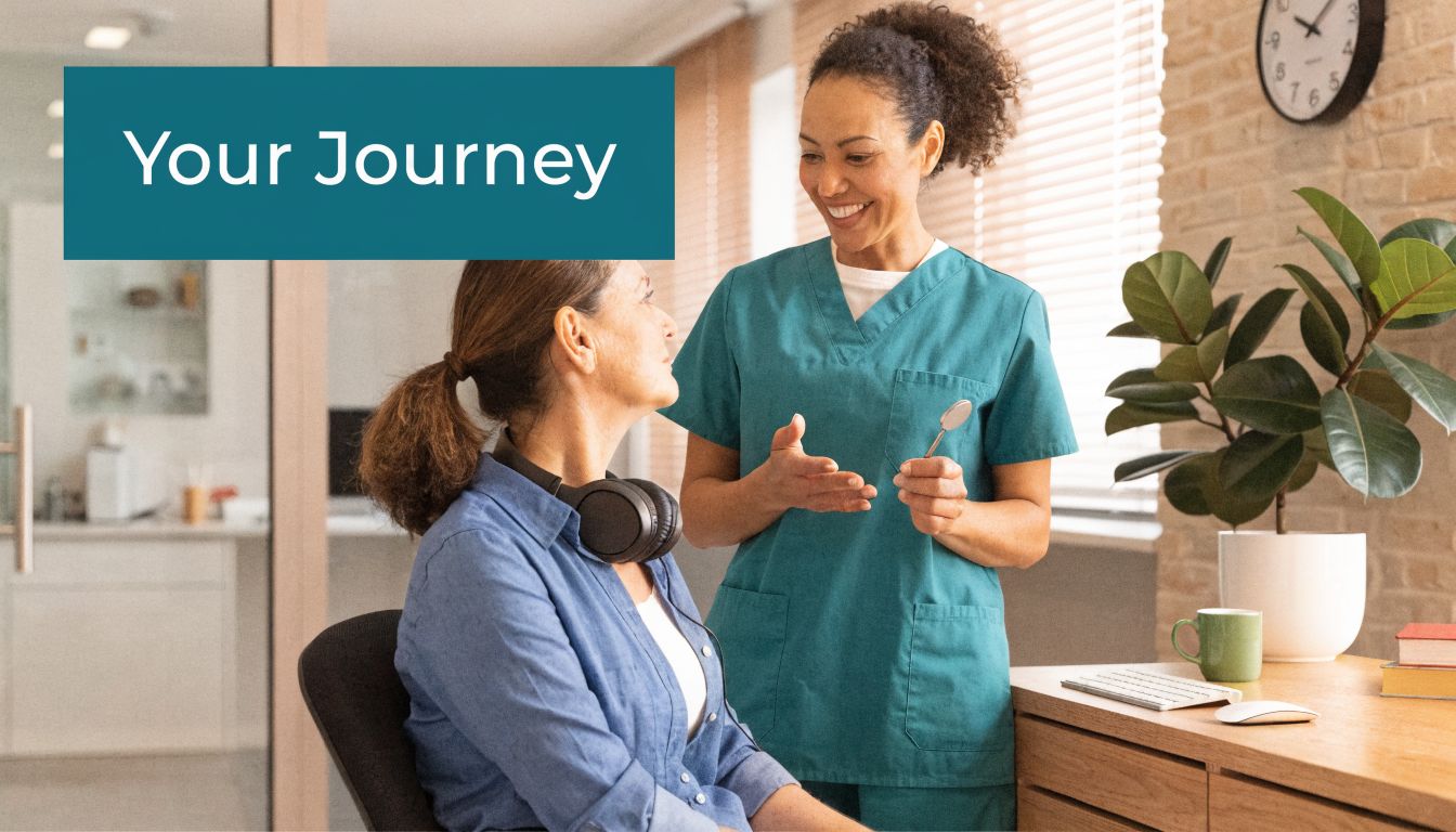 A friendly dental professional talks to a female patient about her dental journey in an office.