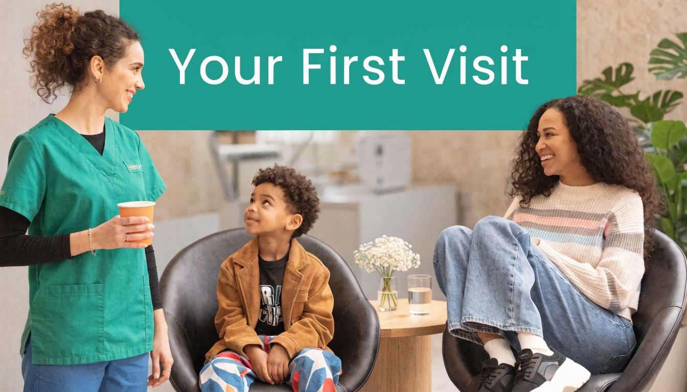 A friendly healthcare professional interacts with a young boy and his mother in a waiting room.