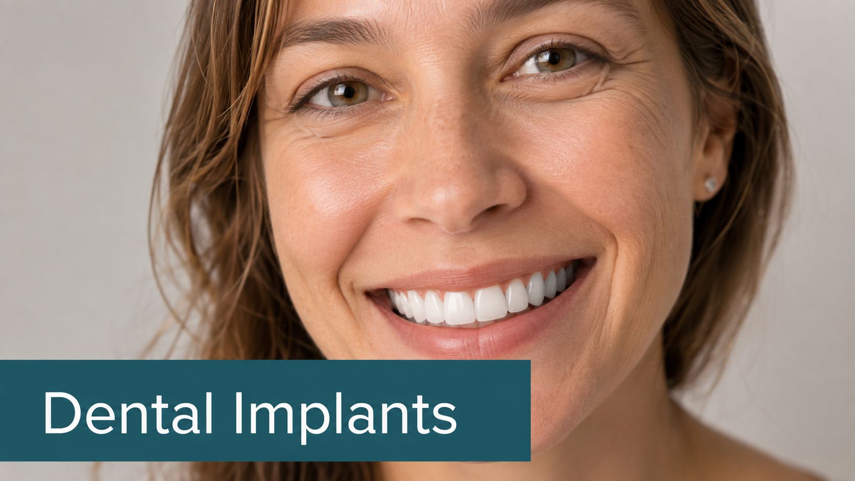 A close-up of a smiling woman with bright, healthy teeth highlighting the benefits of dental implants.