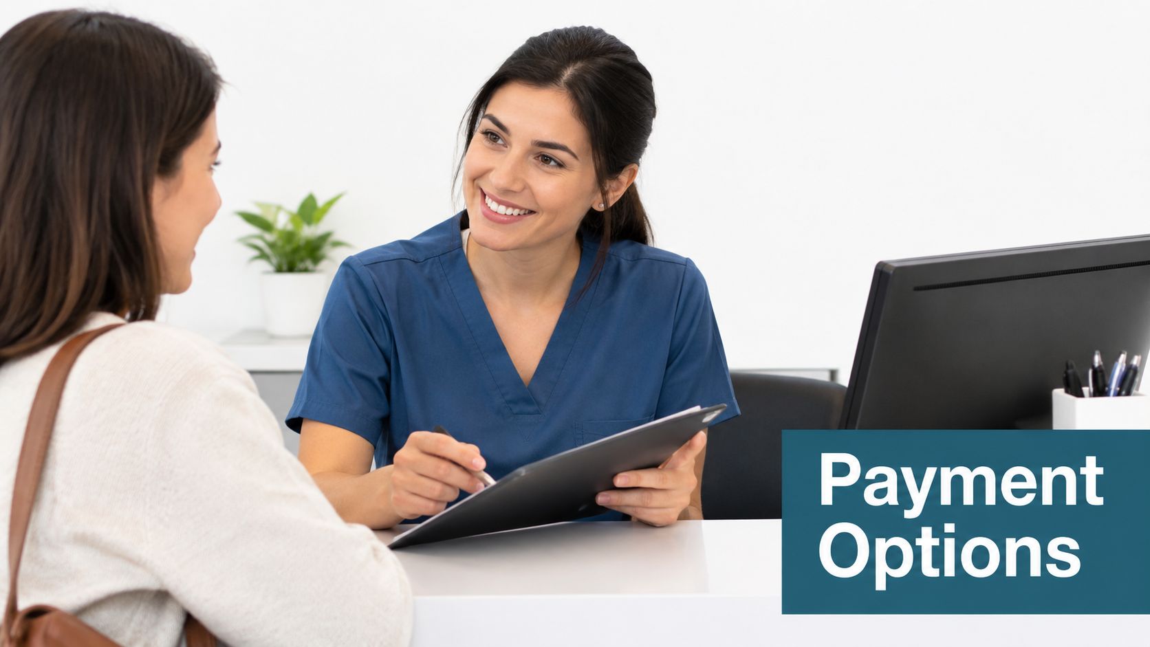 A friendly dental receptionist smiling at a patient while discussing payment options at a modern clinic desk.