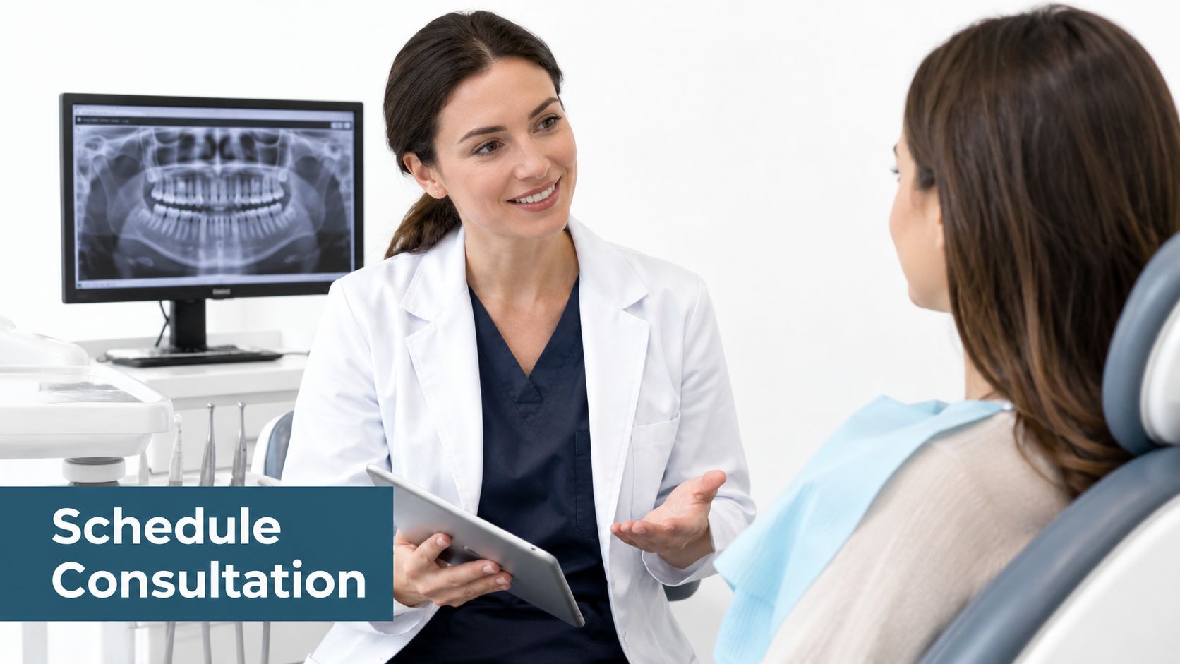 A friendly female dentist explains treatment options to a patient using a tablet in a dental clinic.