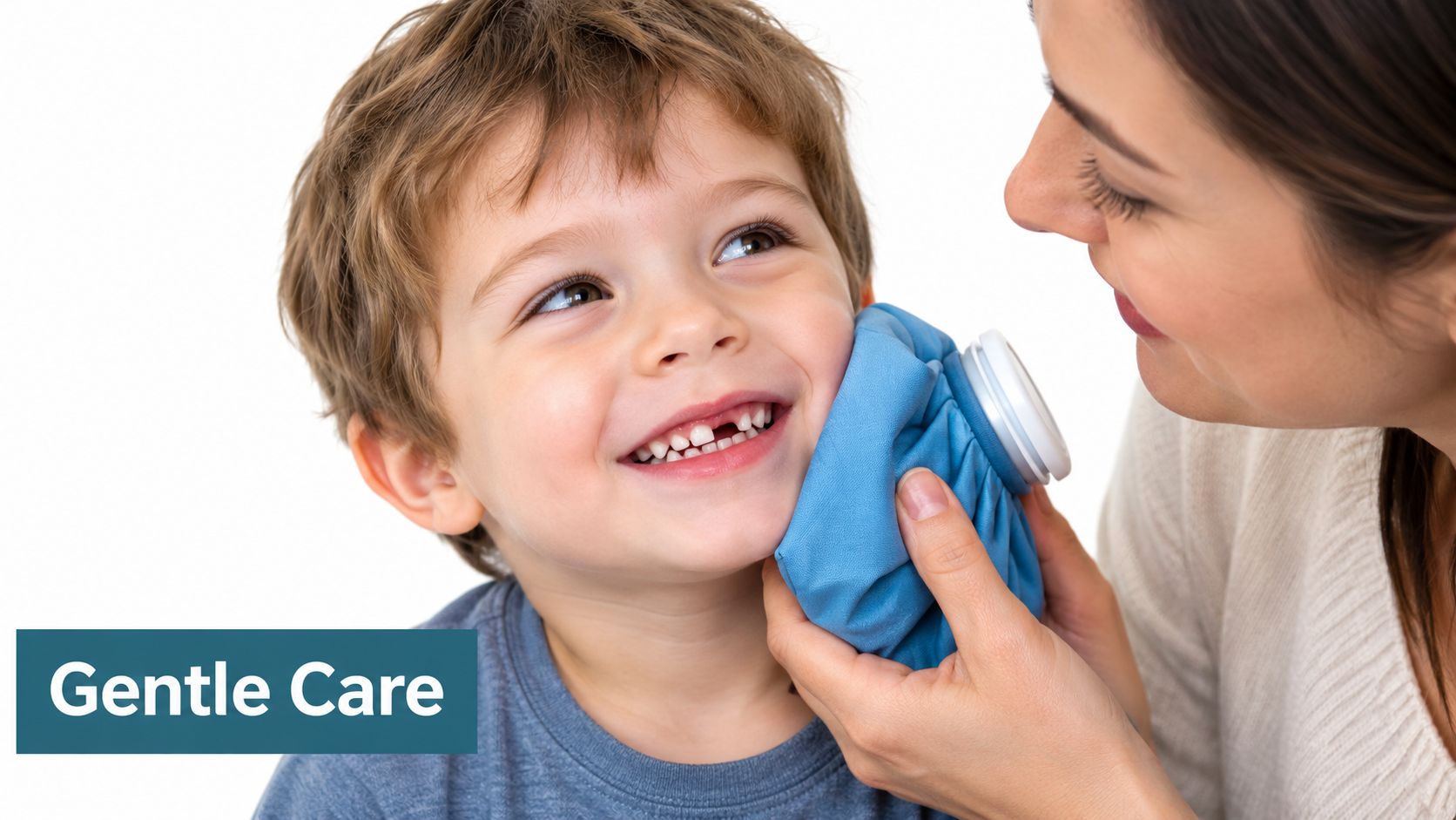 A caring mother holding an ice pack to her smiling young son's cheek after losing a tooth.